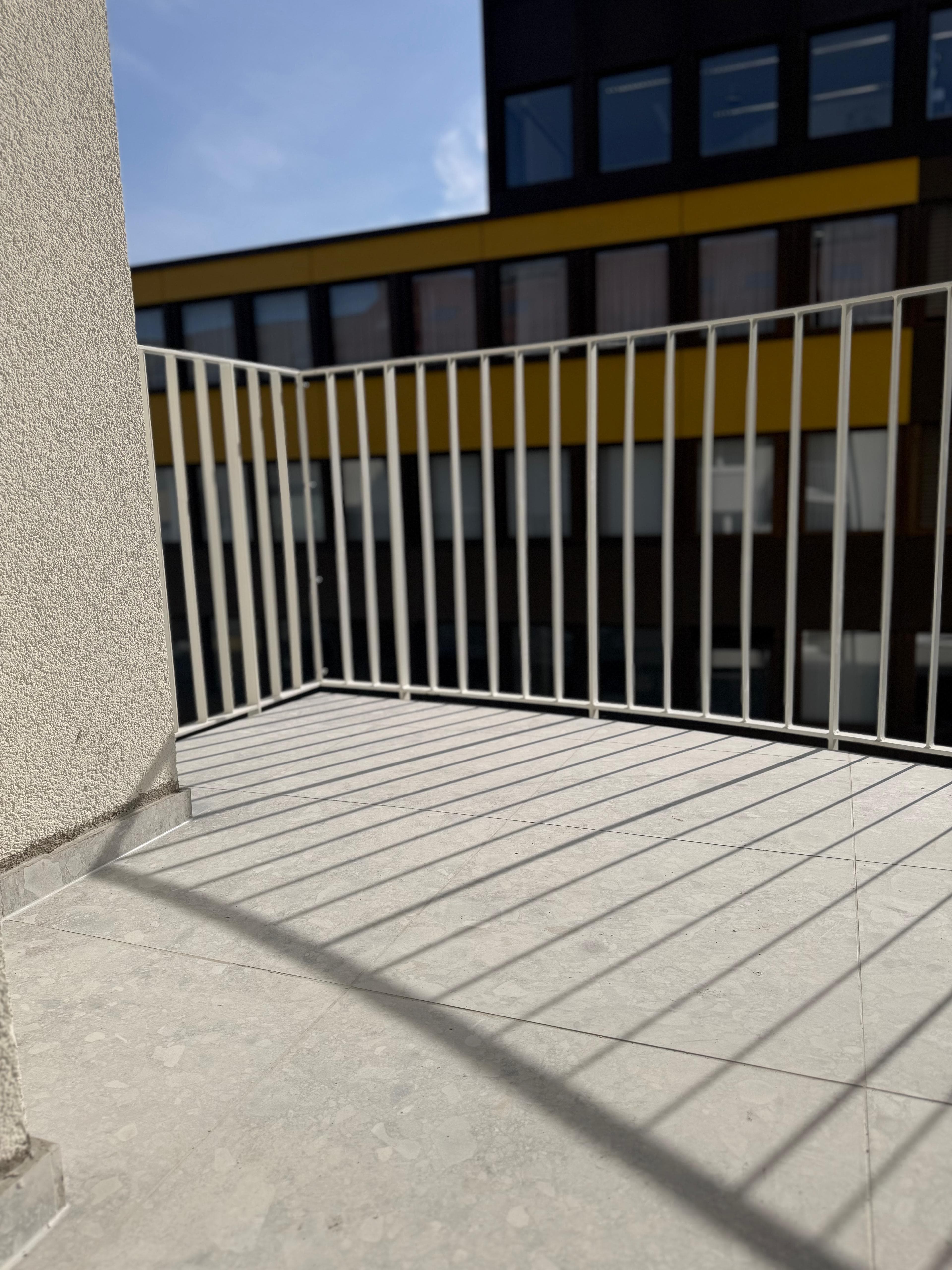 Energetische Sanierung Kriegerstraße, Stuttgart – neu gefliester Balkon mit weißem Geländer